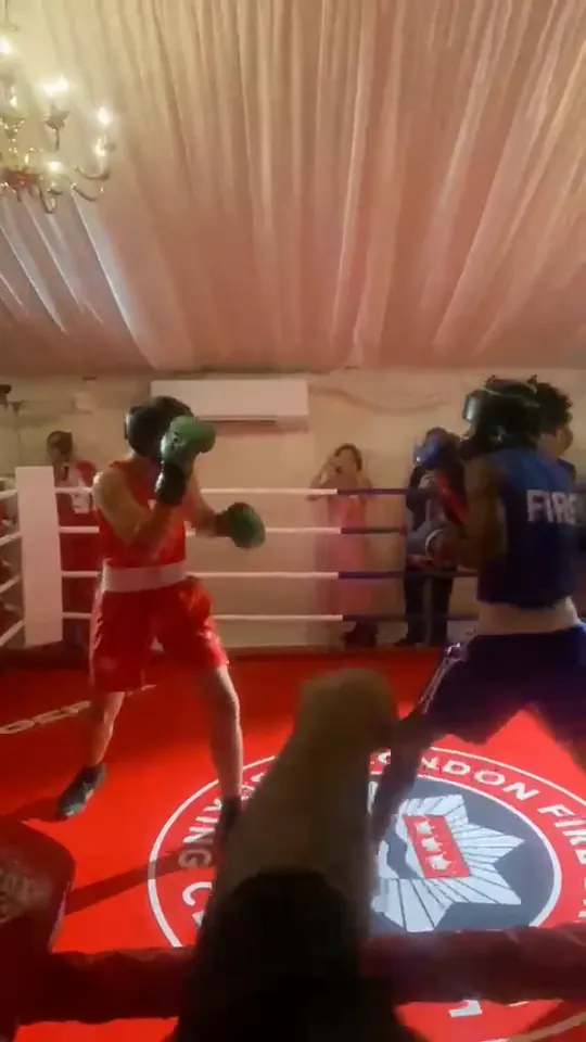 Video of two boxers exchanging punches across the crest while guests line the ring